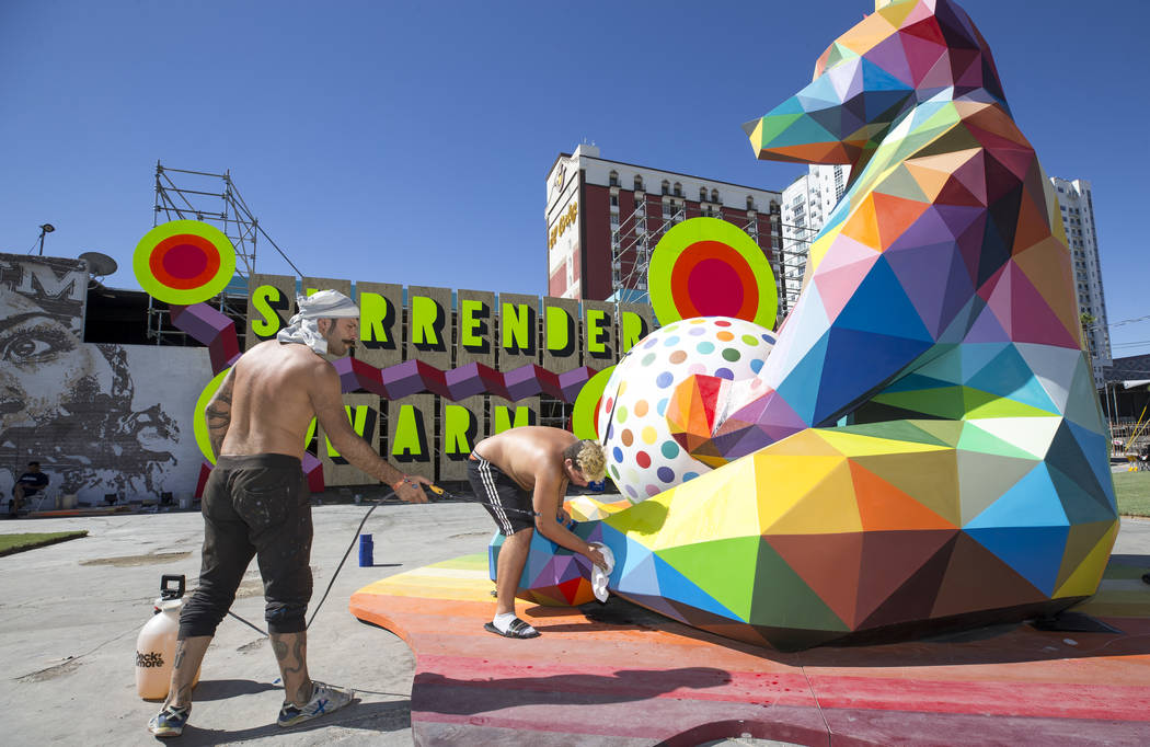 Pablo Hattori, left, and Marcos Martinez, assistants to Spanish street artist Okuda San Miguel, ...