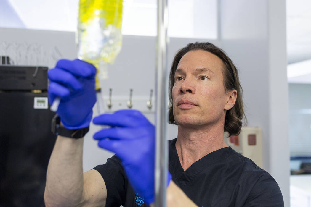 Dr. Jason Burke, founder of pioneering IV-therapy business Hangover Heaven, prepares IV fluids ...