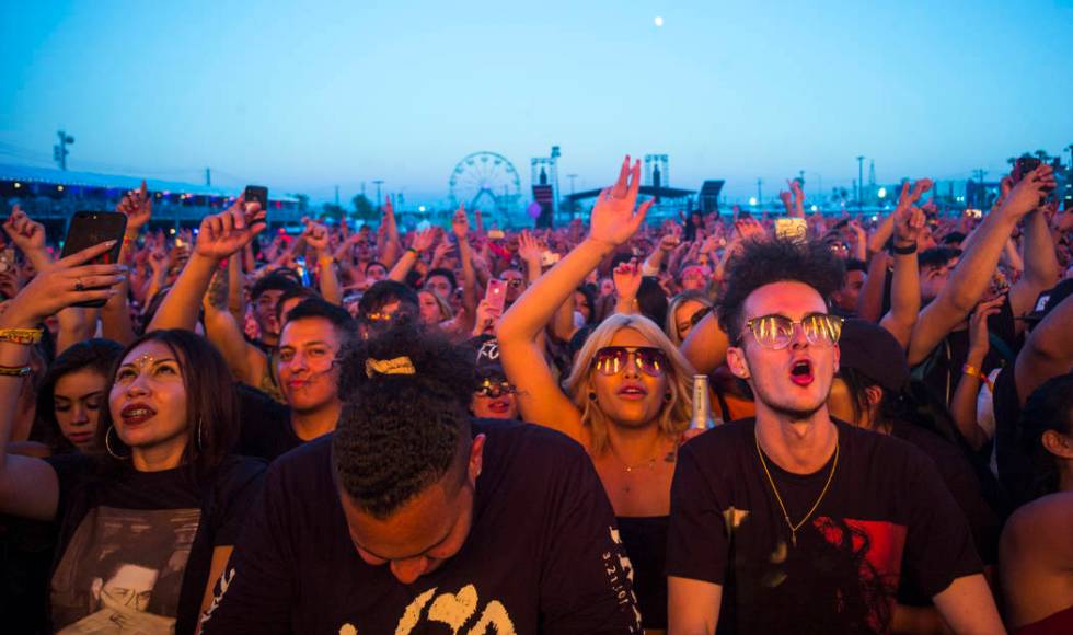 Fans react as French Montana performs at the Downtown stage during the first day of the annual ...