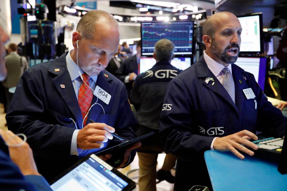 Trader Michael Urkonis, left, and specialist James Denaro work on the floor of the New York Sto ...