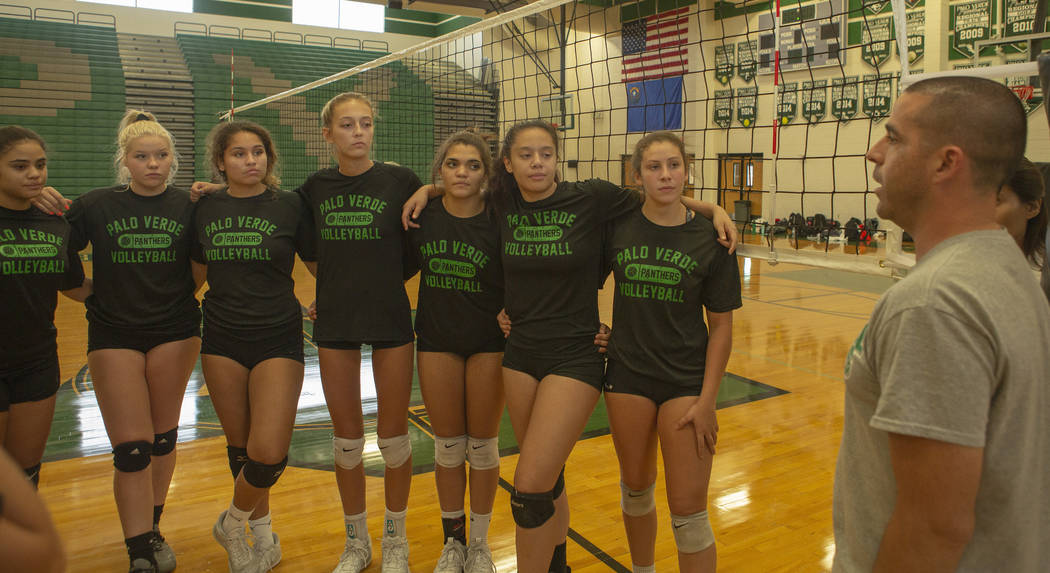 The varsity volleyball team listen to their coach during practice at Palo Verde High School on ...