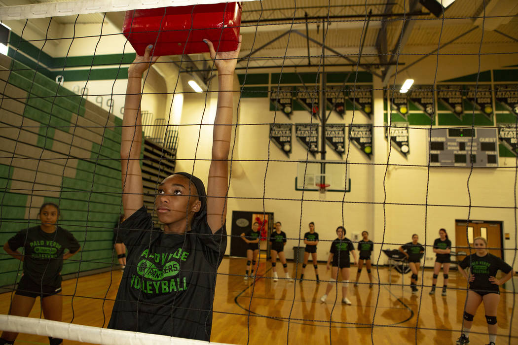 Naomi White, 14, freshman, holds a pad to work on defense during volleyball practice at Palo Ve ...