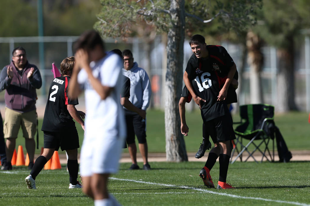 Las Vegas' Sergio Aguayo (18) is lifted up by Nathan Zamora (16) in celebration after his goal ...