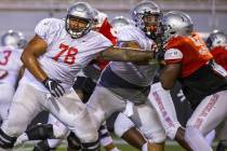 Offensive lineman Justin Polu (78) blocks out defensive lineman Dominion Ezinwa (93, right) dur ...