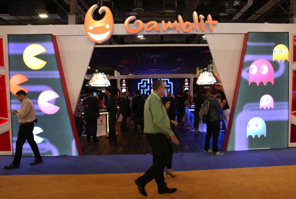 Expo goers walk past the Gamblit Gaming booth during Global Gaming Expo at the Sands Expo and C ...