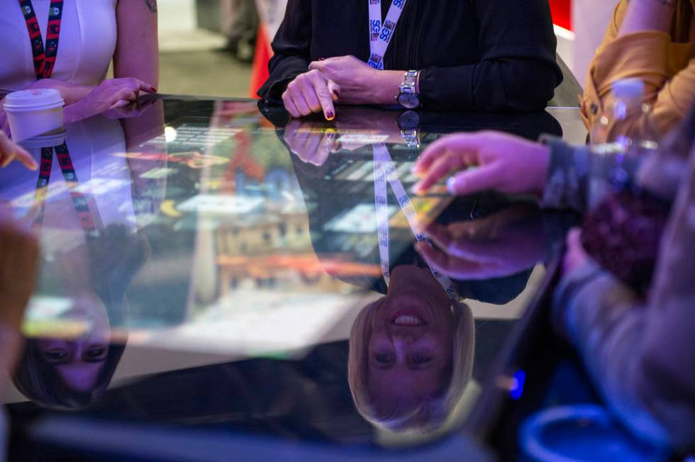 Attendees play Pac-Man, a skill-based game, at Gamblit booth at the 18th annual Global Gaming E ...