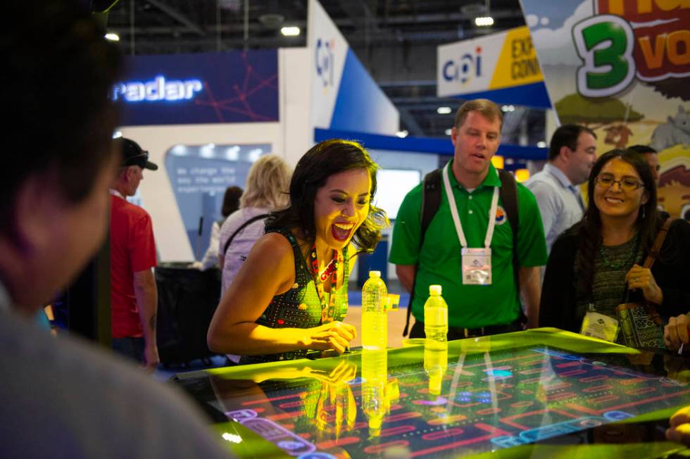 Nikki Tuazon shows attendees how to play the new Gamblit Pac-Man game at the 18th annual Global ...