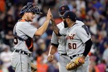 Detroit Tigers' John Hicks, left, celebrates with Ronny Rodriguez (60) and Joe Jimenez after a ...