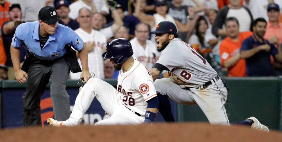 Houston Astros' Robinson Chirinos (28) is tagged out by Detroit Tigers third baseman Dawel Lugo ...