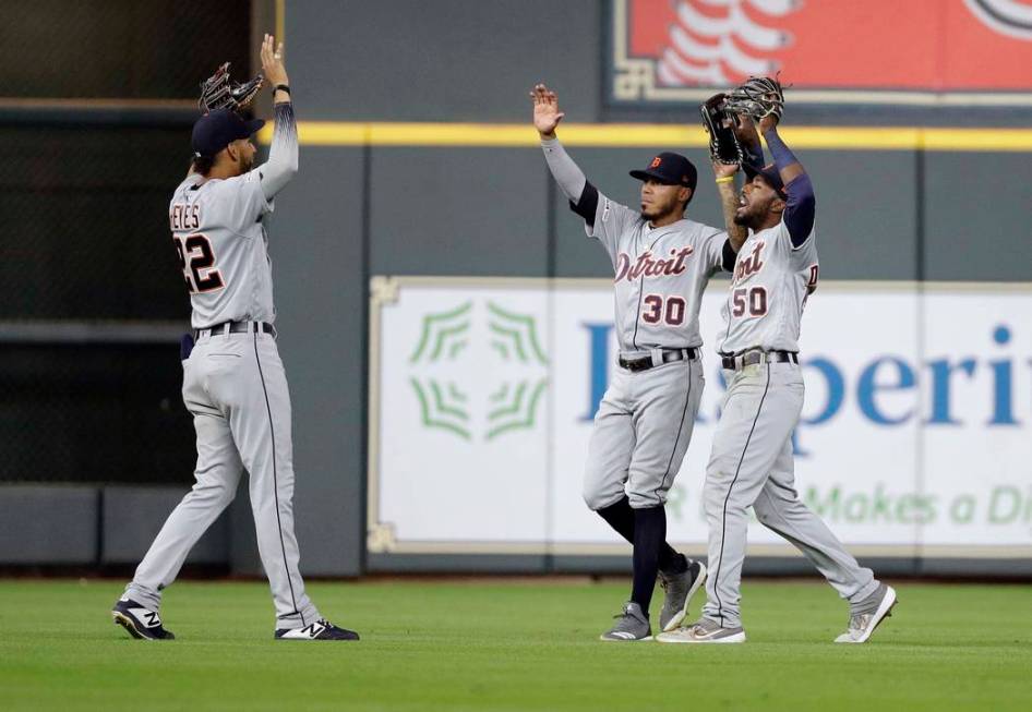 Detroit Tigers' Victor Reyes (22), Harold Castro (30) and Travis Demeritte (50) celebrate after ...