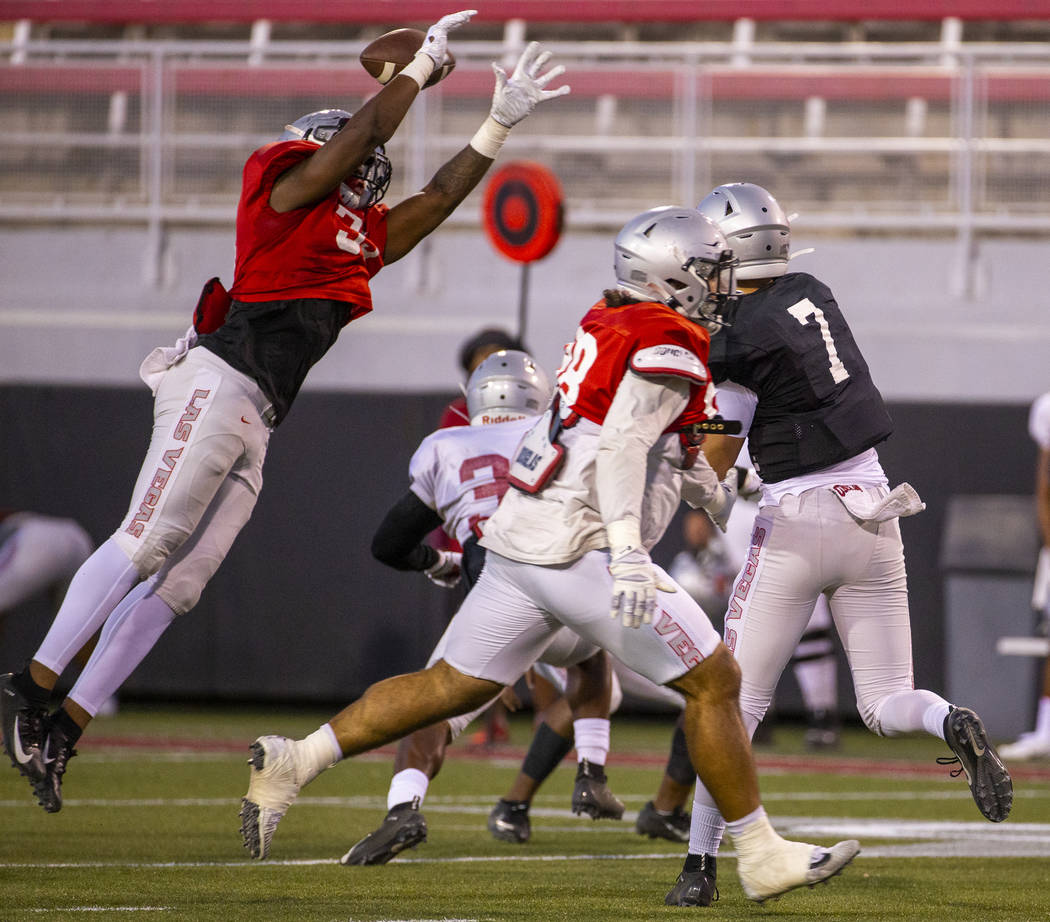 Jacoby Windmon (35) deflects a pass from QB Kenyon Oblad (7) during the UNLV football team scri ...