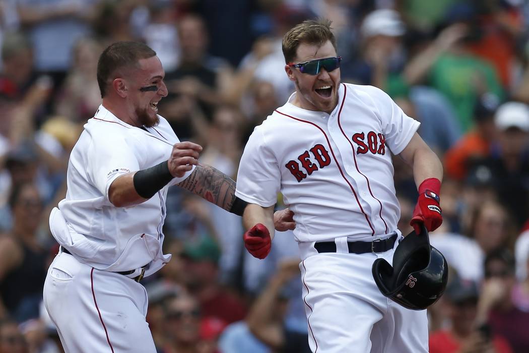 Boston Red Sox's Brock Holt, right, celebrates his game-winning RBI single with Christian Vazqu ...