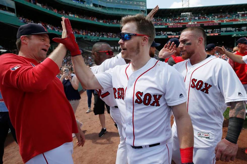 Boston Red Sox's Brock Holt, center, celebrates is game-winning RBI single during the 10th inni ...