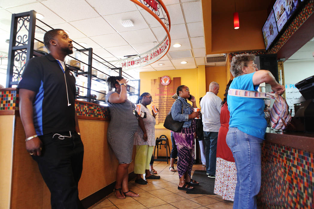 People wait in line, some as long as an hour, for the new chicken sandwich at Popeyes on the co ...