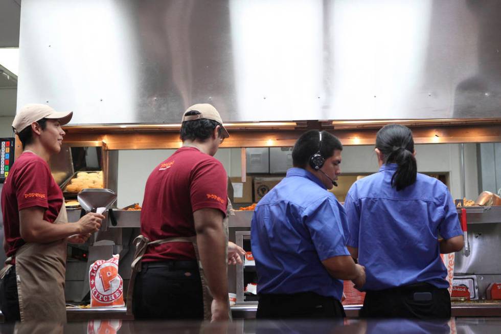 Popeyes employees work around the clock to fulfill orders of the new chicken sandwich at Popeye ...