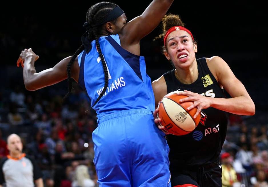 Las Vegas Aces' Dearica Hamby moves the ball around Atlanta Dream's Elizabeth Williams (1) duri ...