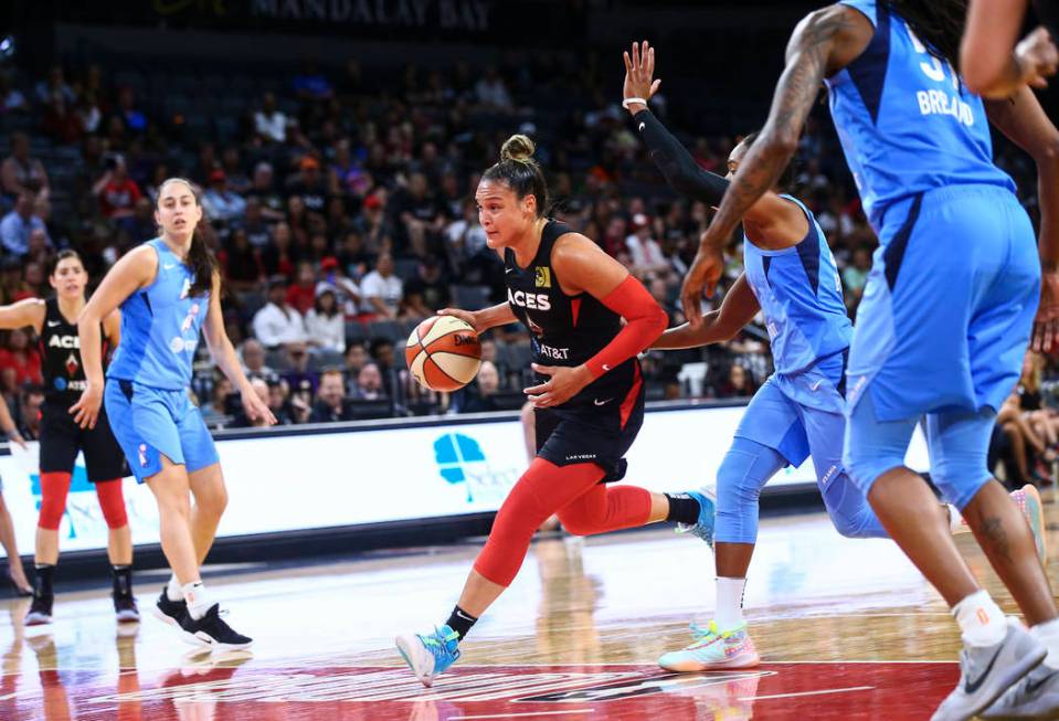 Las Vegas Aces' Kayla McBride drives to the basket past Atlanta Dream's Alex Bentley during the ...