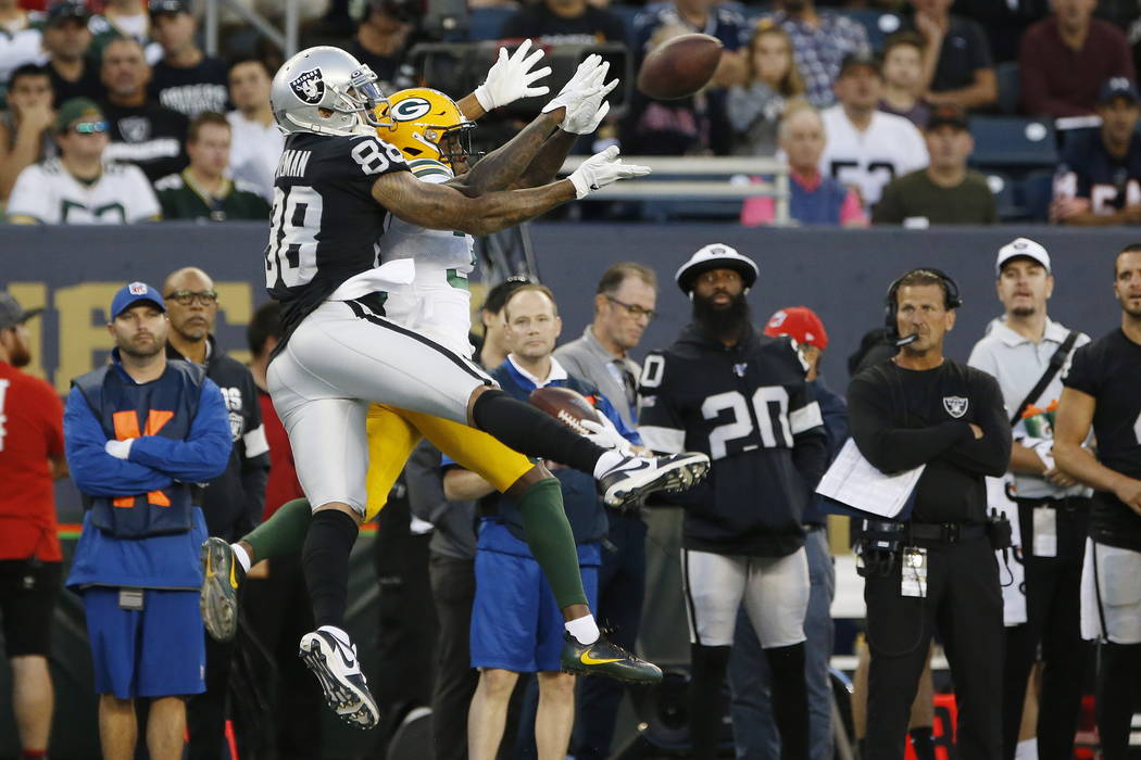Oakland Raiders' Marcell Ateman (88) goes up for a pass as Green Bay Packers' Chandon Sullivan ...