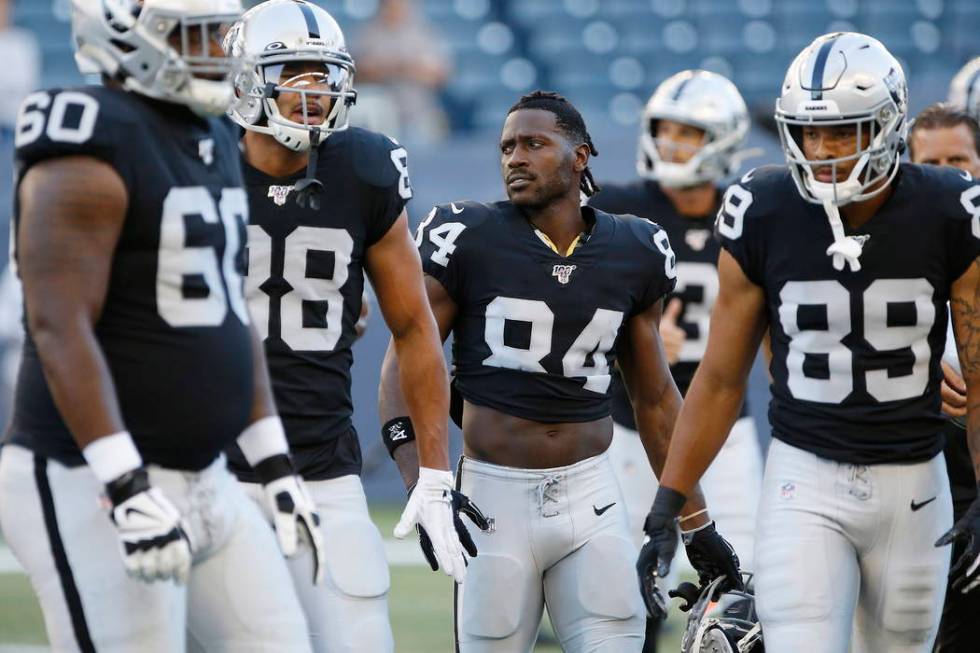 Oakland Raiders' Antonio Brown (84) and teammates gather before an NFL preseason football game ...