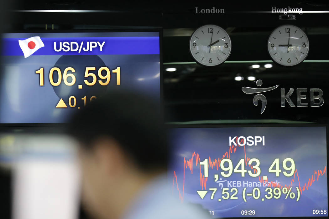 Screens showing the Korea Composite Stock Price Index (KOSPI) and the foreign exchange rates ar ...