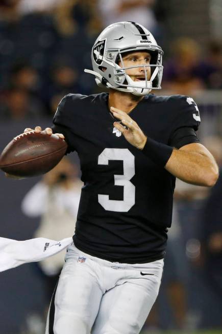 Oakland Raiders quarterback Nathan Peterman looks for a receiver during the second half of the ...