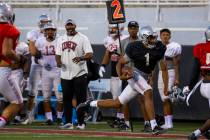 Quarterback Armani Rogers (1) streaks down the sidelines on a run during the UNLV football team ...