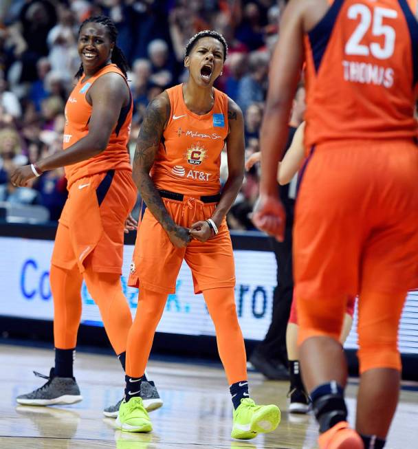 Connecticut Sun guard Courtney Williams, center, celebrates with teammates Shekinna Stricklen, ...