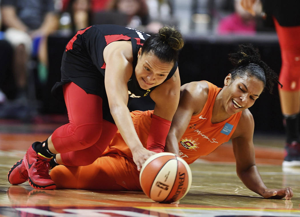 Connecticut Sun forward Alyssa Thomas, right, and Las Vegas Aces guard Kayla McBride dive after ...