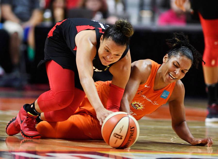 Connecticut Sun forward Alyssa Thomas, right, and Las Vegas Aces guard Kayla McBride dive after ...