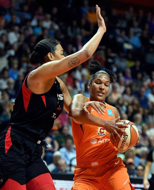 Connecticut Sun forward Alyssa Thomas, right, is fouled by Las Vegas Aces center Liz Cambage du ...