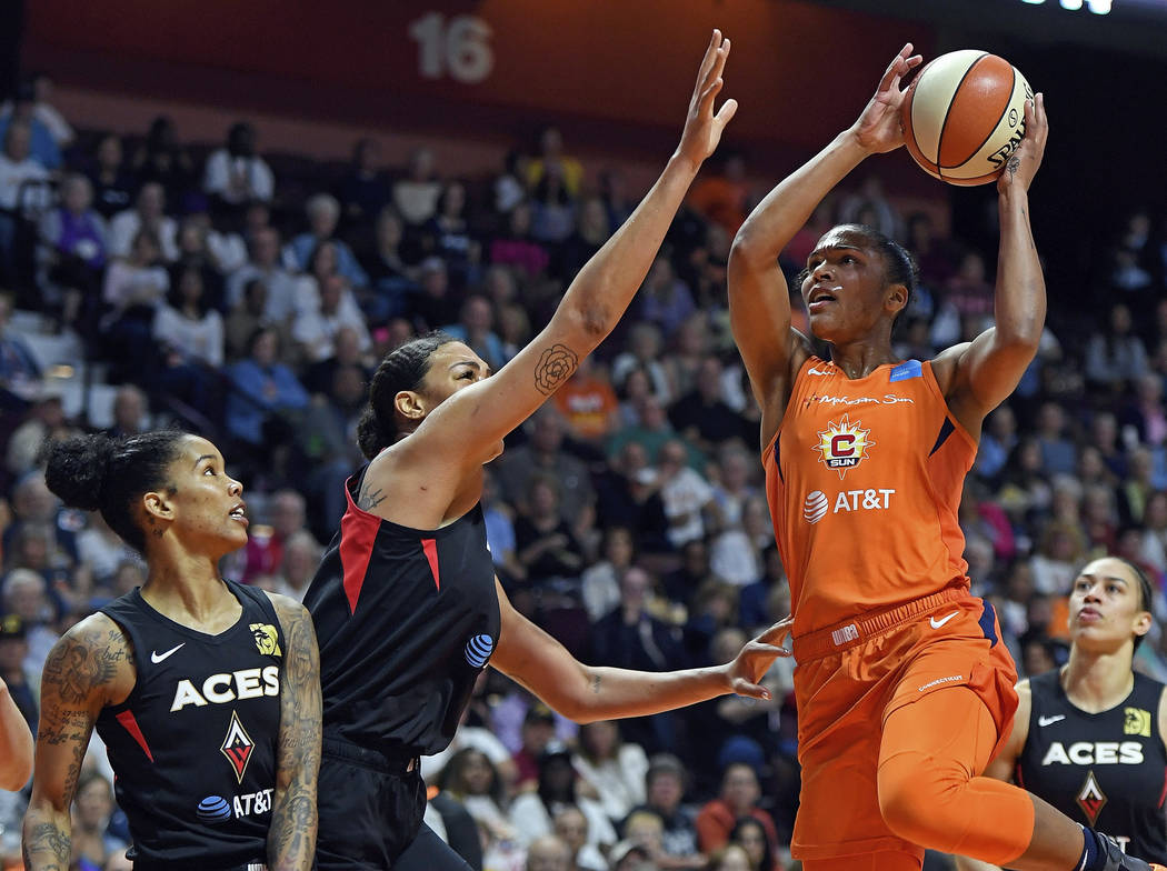 Connecticut Sun forward Alyssa Thomas shoots over the defense of Las Vegas Aces center Liz Camb ...