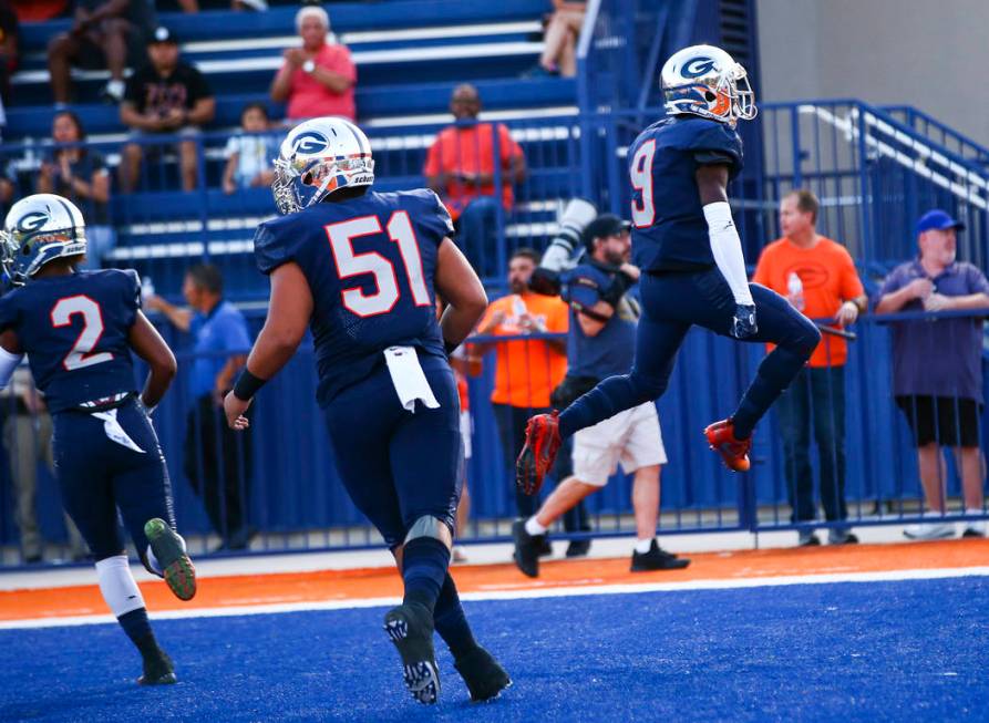 Bishop Gorman's Zachariah Branch (9) celebrates a touchdown against Orem during the first half ...