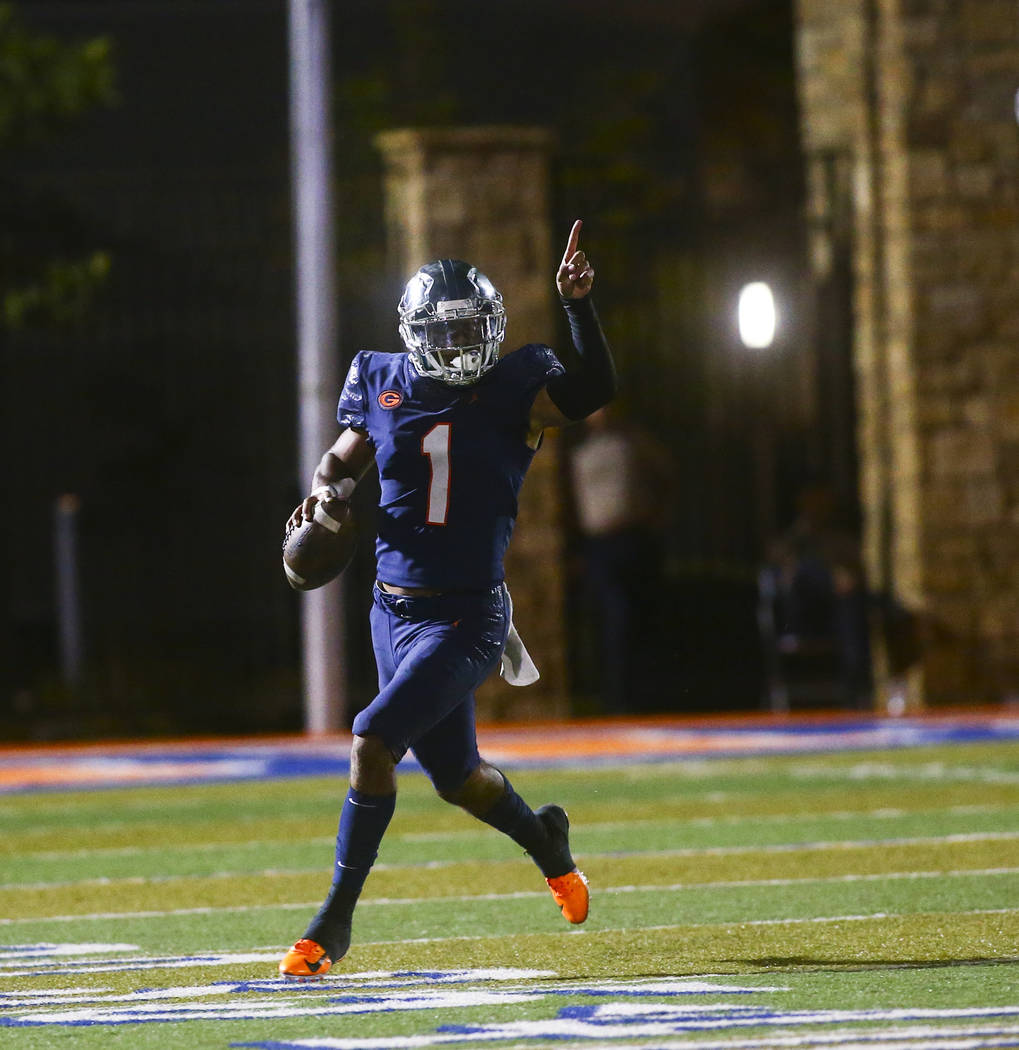 Bishop Gorman's Micah Bowens (1) motions to teammates during the first half of a football game ...