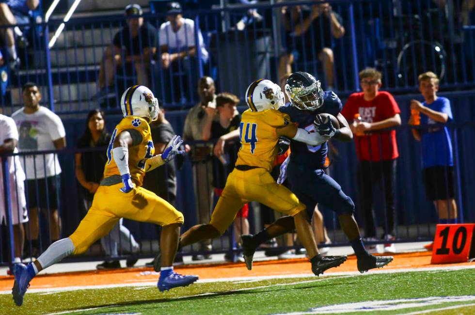 Orem's Kolton Brown (14) stops Bishop Gorman's running back Ikaika Ragsdale (6) during the seco ...