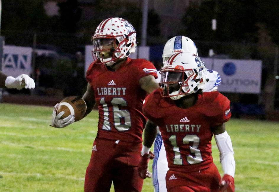 Liberty High's Maurice Hampton (16) runs with the ball during the first half of their game agai ...