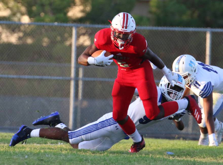 The Liberty High's wide receiver Germie Bernard (2) scrambles away from Chandler, Ariz., High's ...