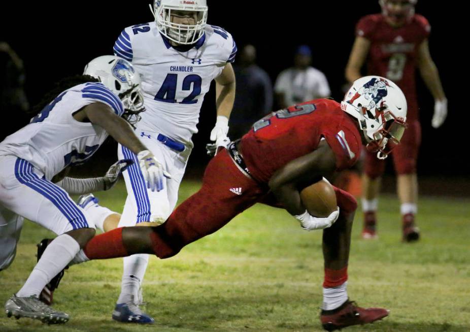 Liberty High's Germie Bernard (2) scrambles away from Chandler, Ariz., High's defense, includin ...