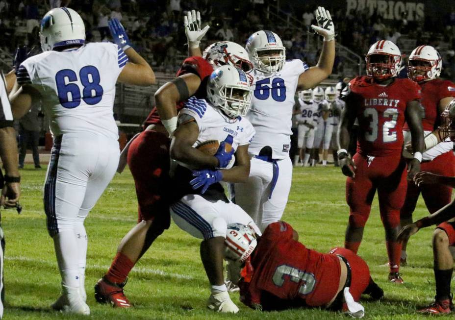 Chandler, Ariz., High's Dae Dae Hunter (4) drives for a touchdown as Liberty High’s Zeph ...