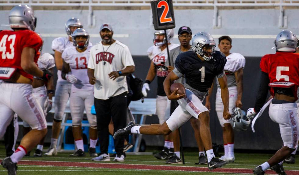 Quarterback Armani Rogers (1) streaks down the sidelines on a run during the UNLV football team ...