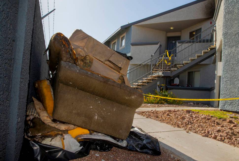 Remains stack up outside from an early morning fire at The Bristol at Sunset apartments in buil ...