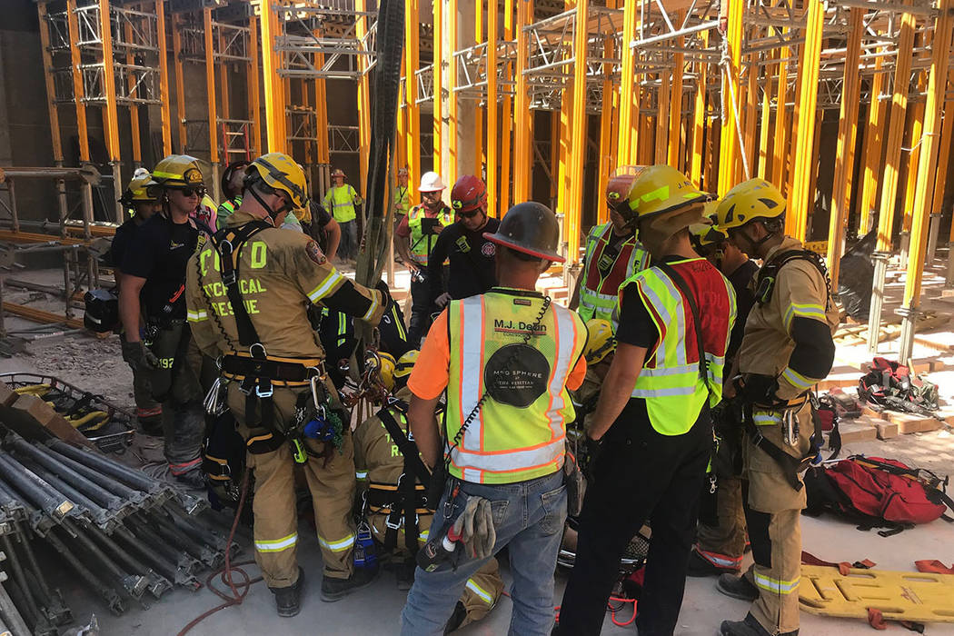 A member of the Clark County Fire Department helps with a rescue of a construction worker Satur ...