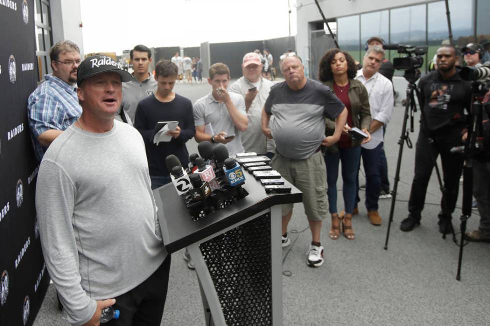 Oakland Raiders head coach Jon Gruden, left, speaks during a news conference after NFL football ...