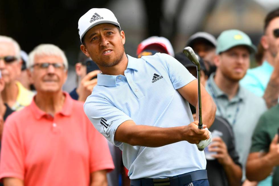 Xander Schauffele hits to the fifth green during the final round of the Tour Championship golf ...