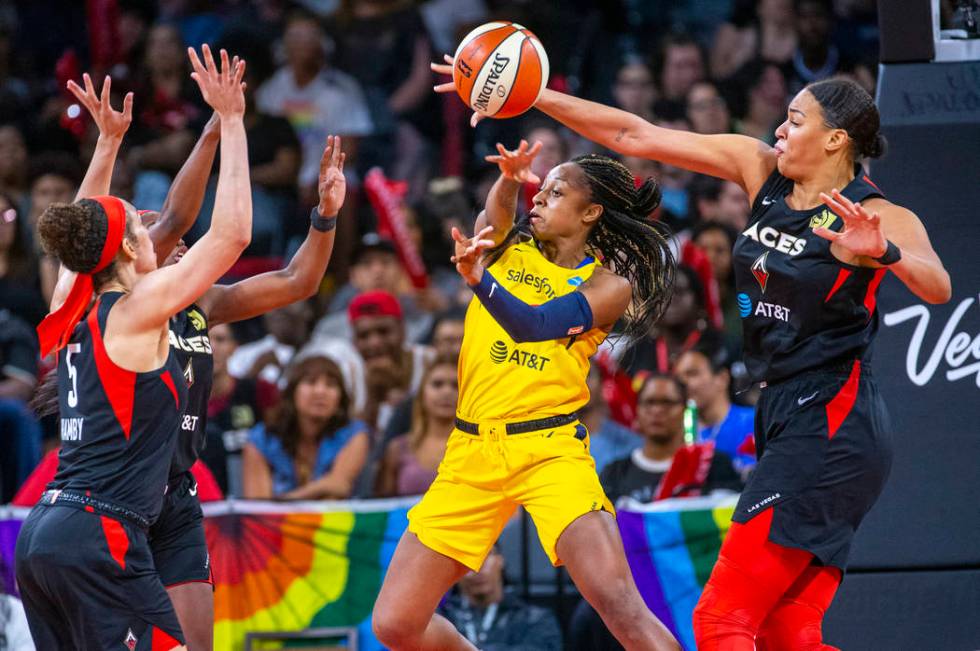 Indiana Fever guard Kelsey Mitchell (0) has a pass deflected by Las Vegas Aces center Liz Camba ...