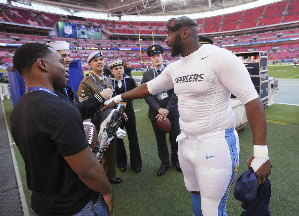 Los Angeles Chargers defensive tackle Corey Liuget greets military personnel before an NFL foot ...