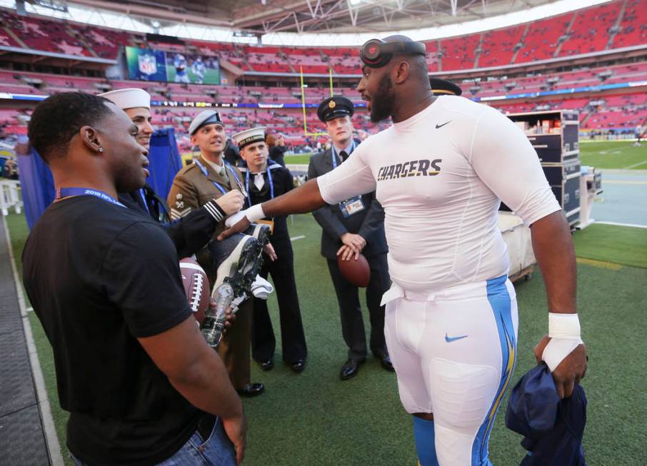 Los Angeles Chargers defensive tackle Corey Liuget greets military personnel before an NFL foot ...