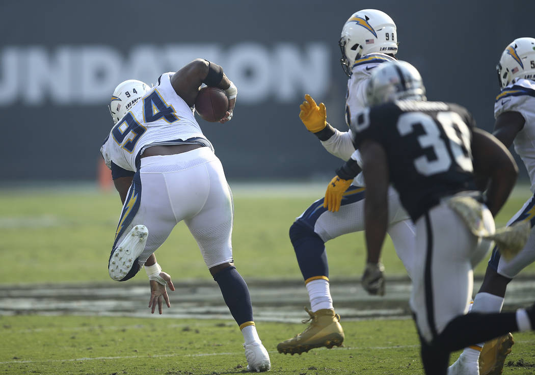 Los Angeles Chargers defensive tackle Corey Liuget (94) runs after recovering a fumble against ...