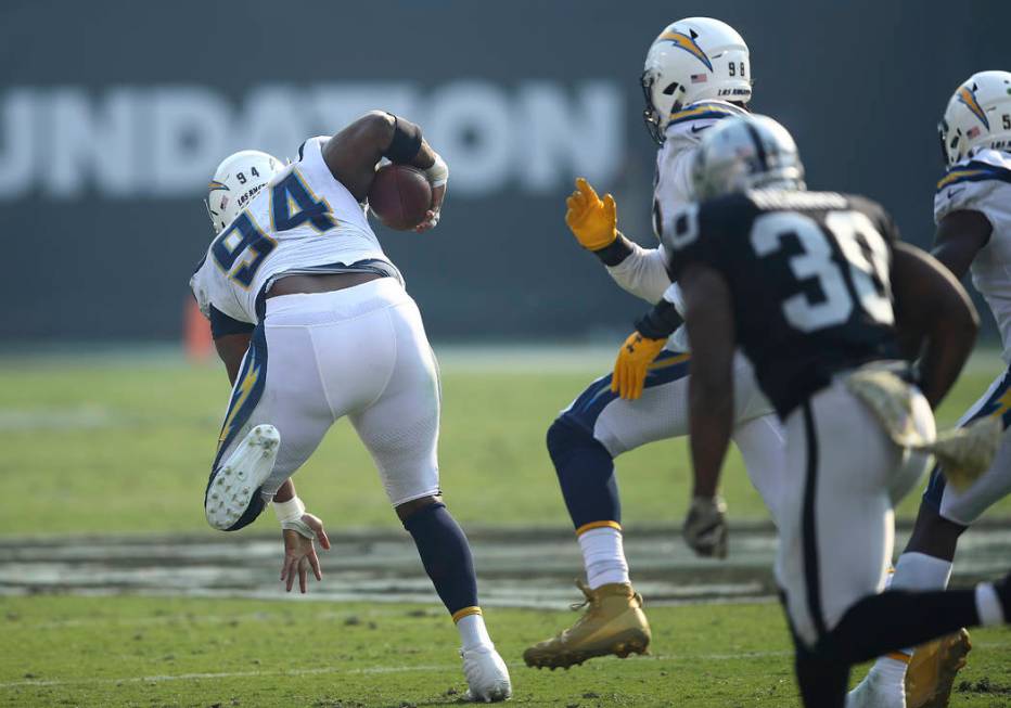 Los Angeles Chargers defensive tackle Corey Liuget (94) runs after recovering a fumble against ...