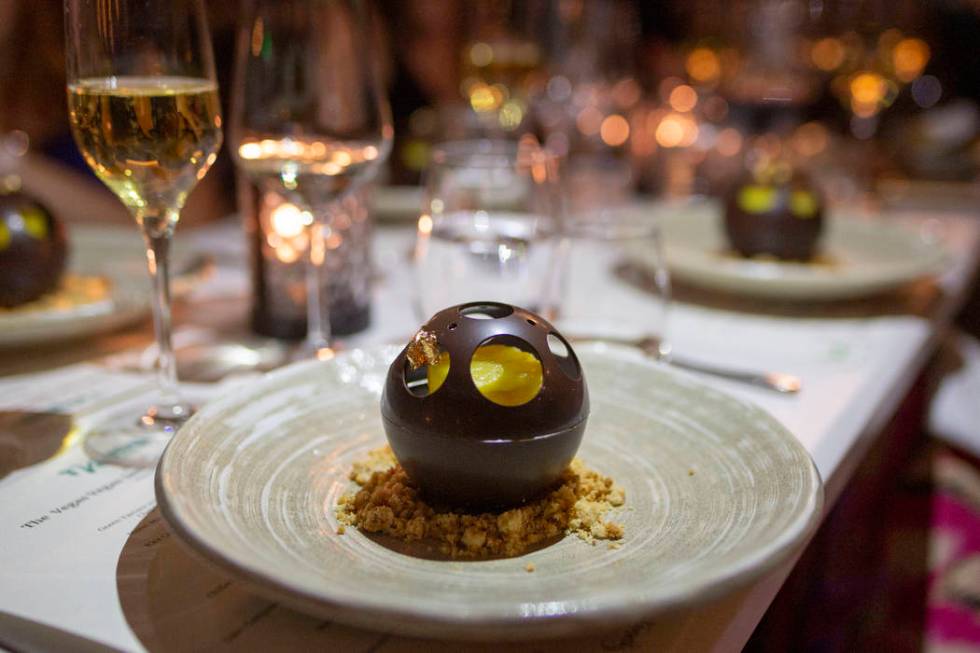 Chocolate Sphere with Coconut Mousse and Candied Pineapple as the final course for the recreati ...