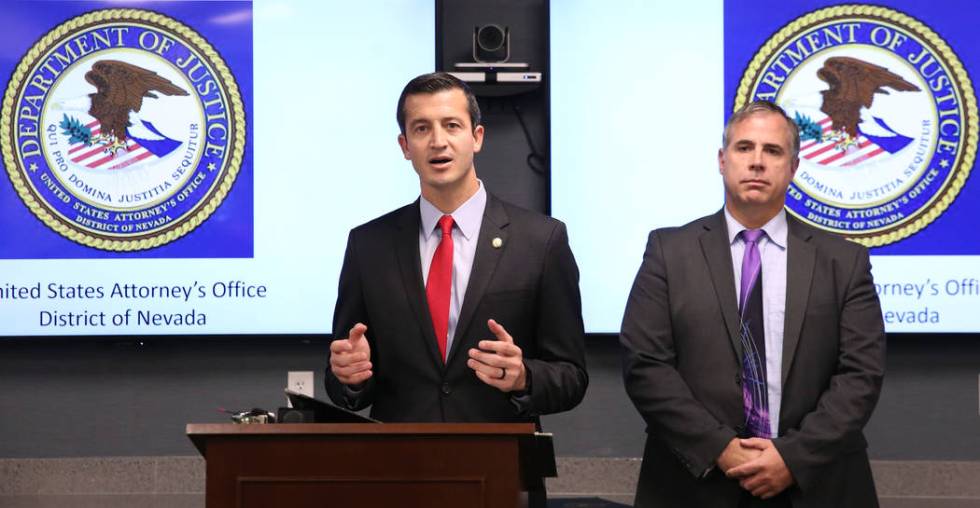 Ray Johnson, right, assistant special agent in charge of the FBI's Las Vegas office, listens as ...